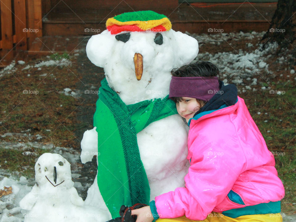 One of my daughters hugging the Reggae snowman and his little brother. She built them with her sister in one of the rare snowfalls we experience on our island. Hugs were necessary because she knew they wouldn’t be around very long! ⛄️