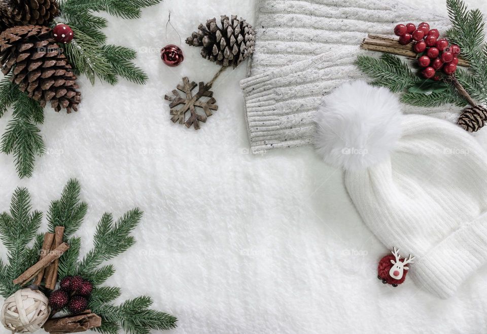 Wintery flat lay with knitwear and winter decorations on a soft fleeced blanket