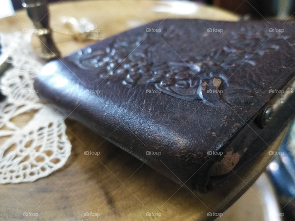 The workmanship of this antique handmade leather lady's change purse shows it's wear and tear.