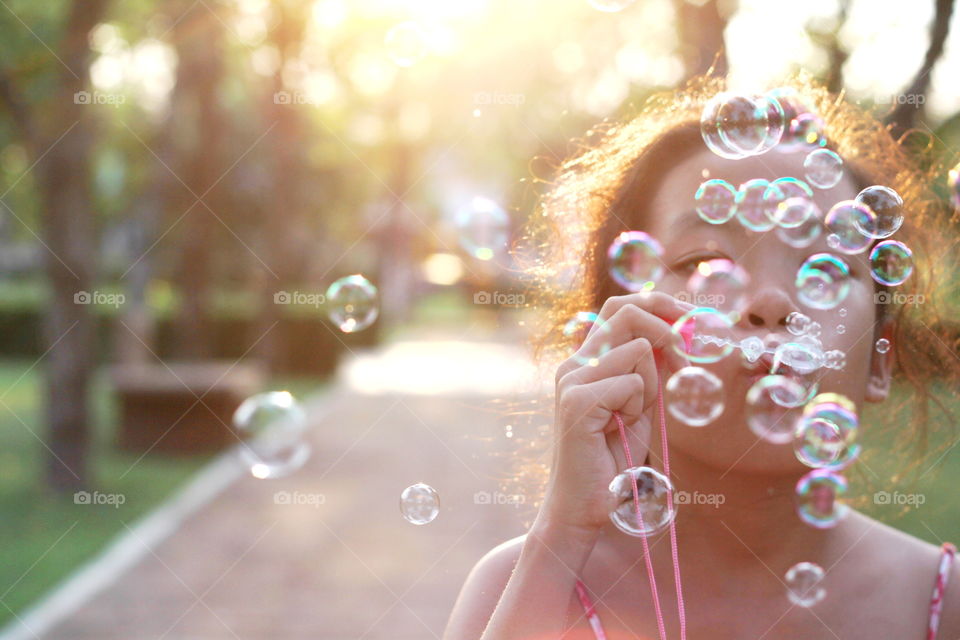 Girl playing soap bubble 