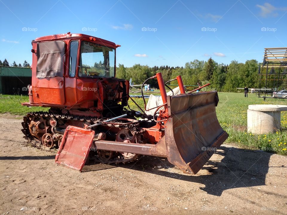 rusty tractor. old, almost functional rusty tractor, in the middle of russian country side