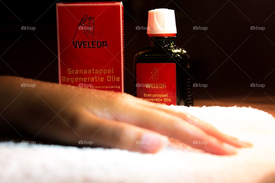 Weleda oil with a hand on a towel