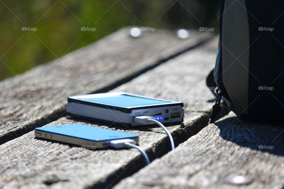 Close-up of smart phone connect to power bank