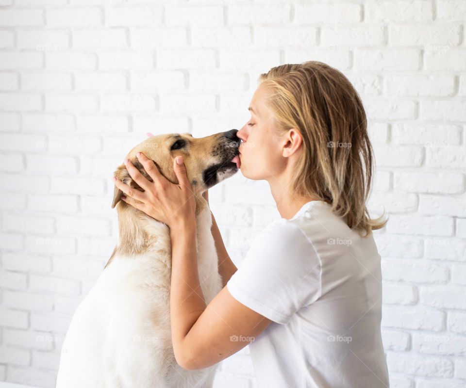 woman kissing her dog