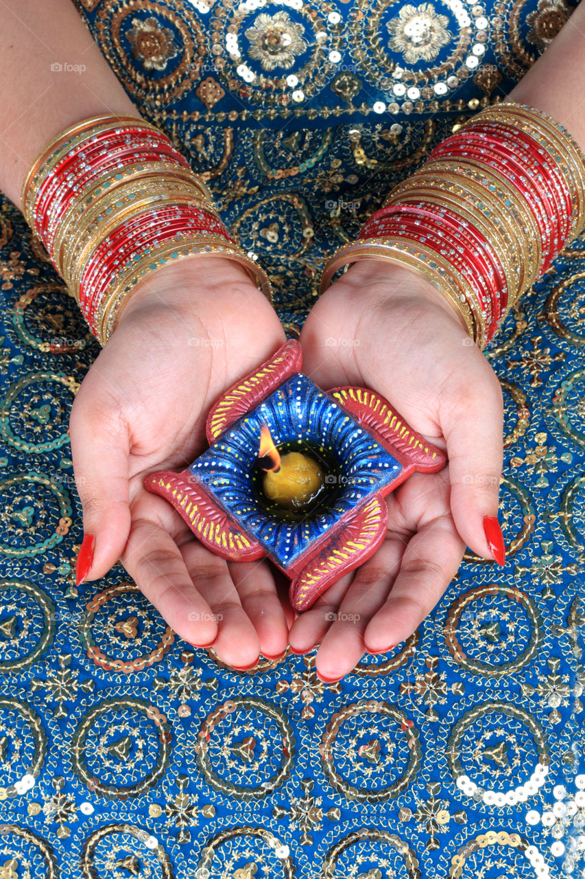 Diwali celebrations - handmade diya oil lamp on female hand