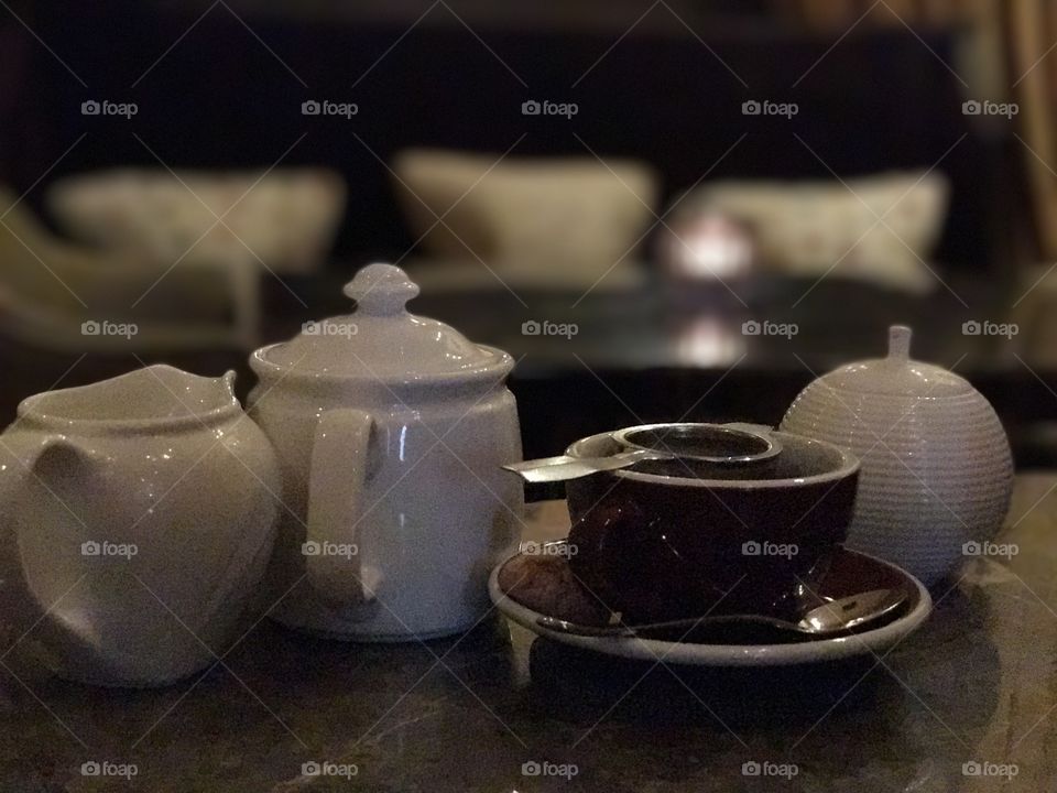 English tea with tea strainer and teapot