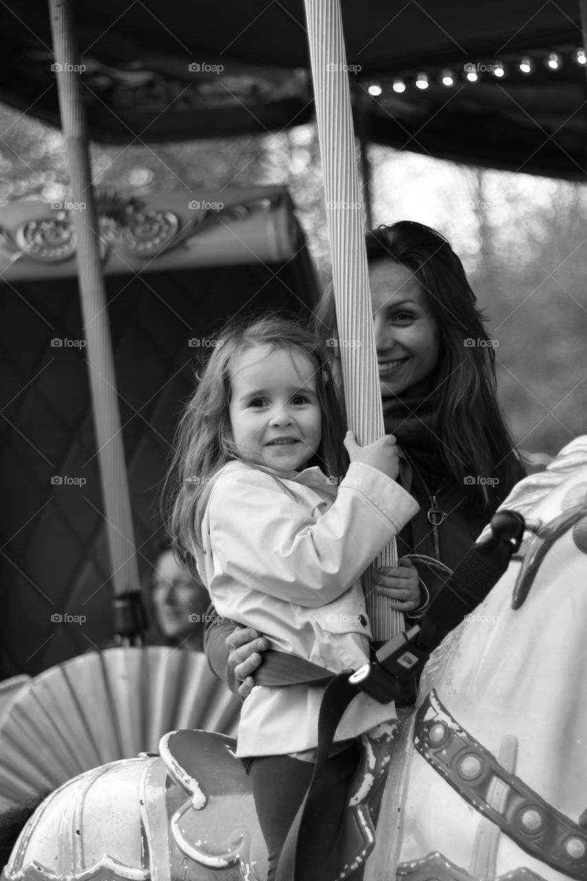 A mother and daughter having fun on a fairground attraction