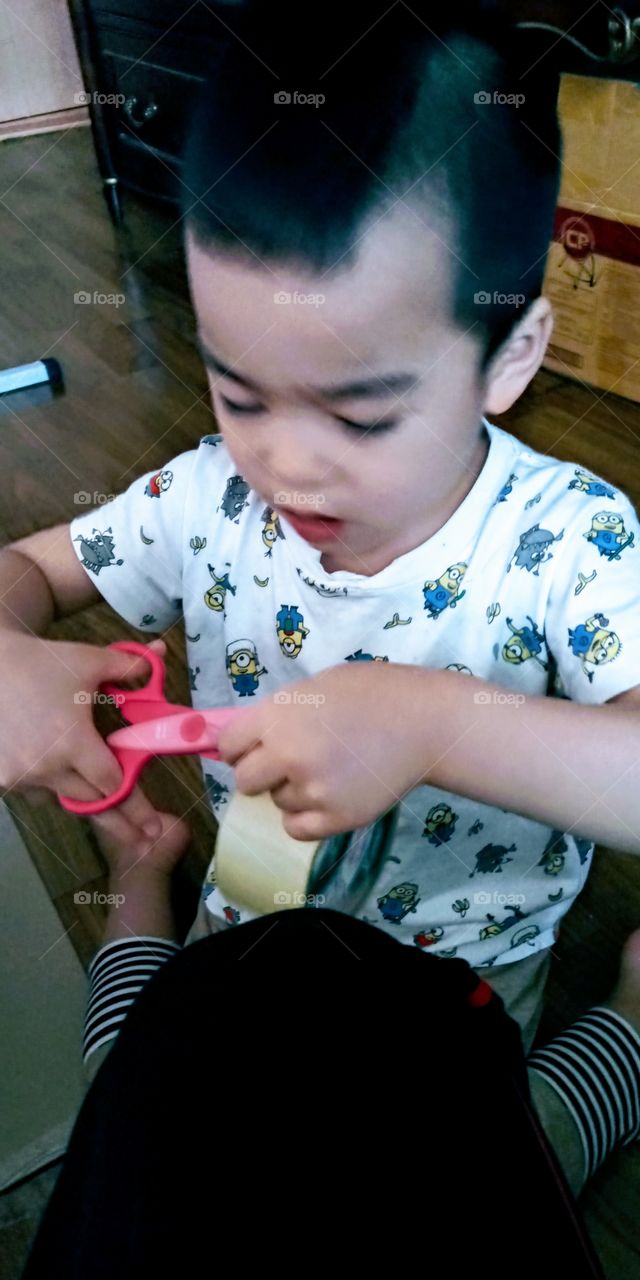 cutting tapes to build  his ideal room.