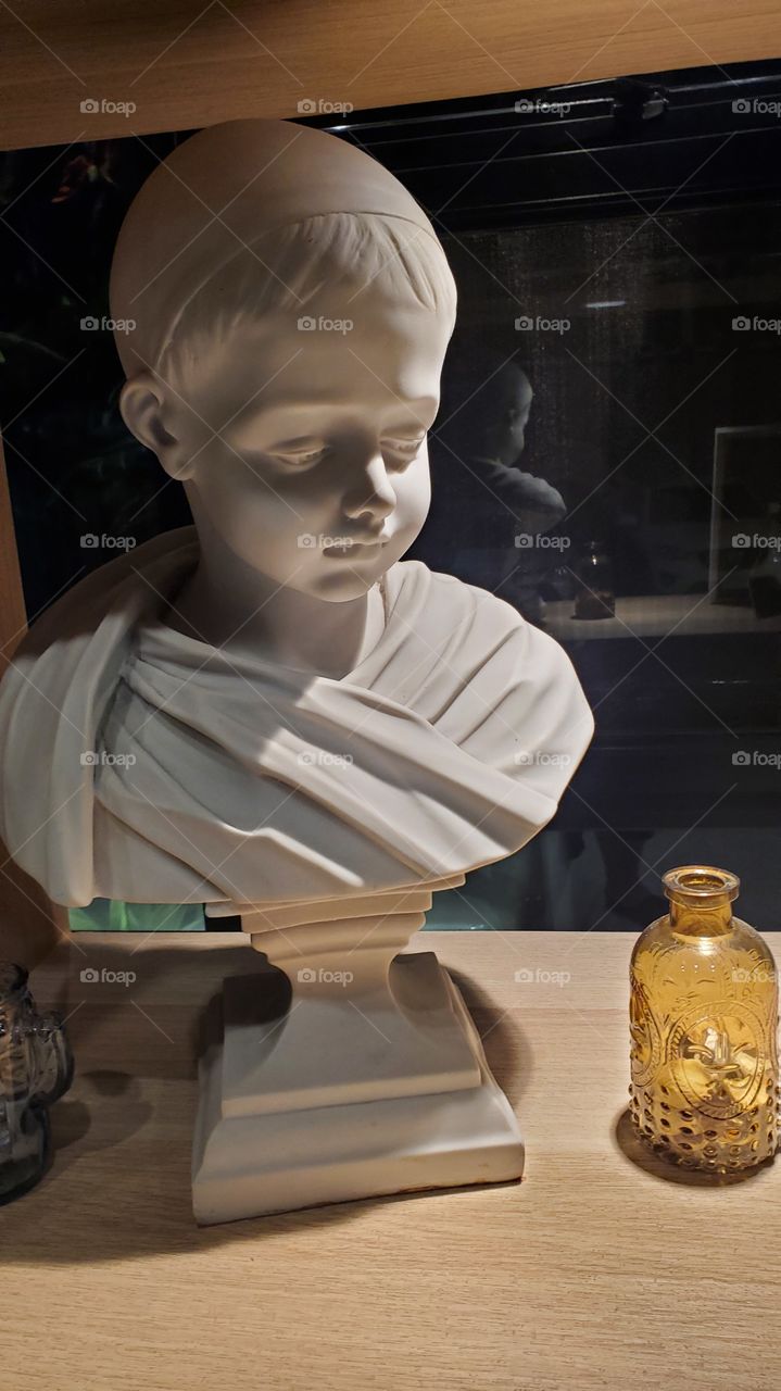 sad boy statue decorated in a hotel