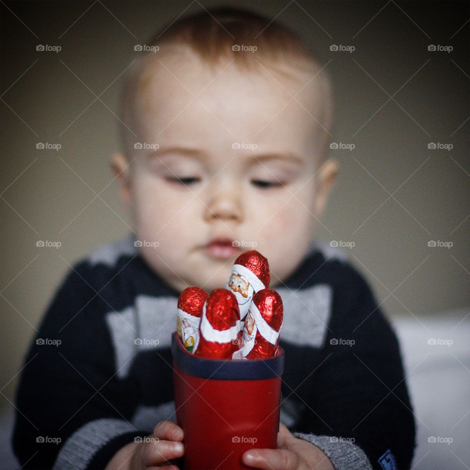 Cute baby holding christmas chocolate