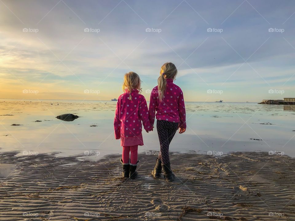 Young sister holding hands