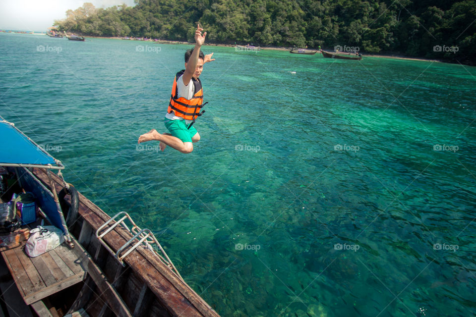 Man jump out of the boat into the ocean 