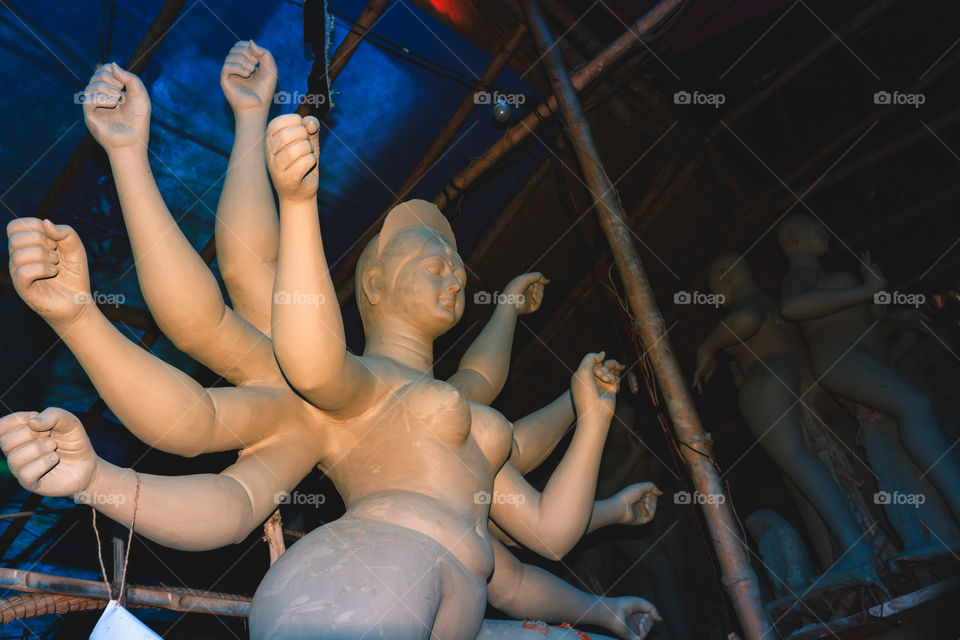Handmade clay model of "Maa Durga" or " Devi Durga"- Hindu woman Idol close up. Snapped in the beginning of city famous Bengali festival of Kolkata or Calcutta, West Bengal, India, Asia
