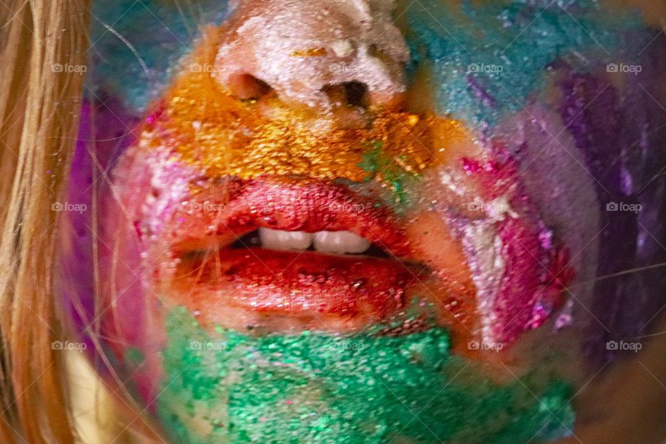 A child wearing glitter makeup