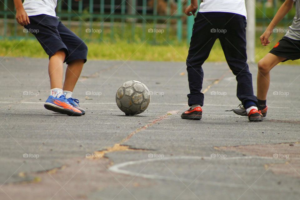 children in the old stadium play football.