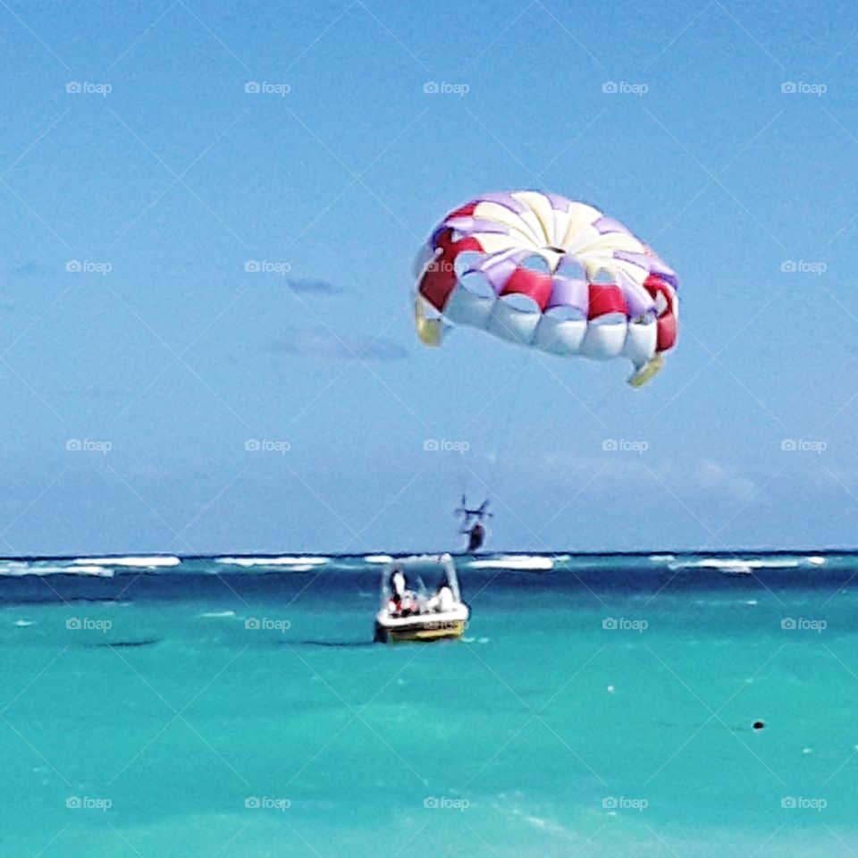 boat and parachute ocean parasailing