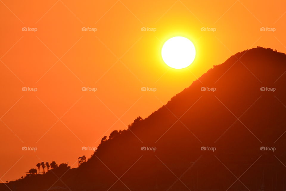 sunset behind a mountain