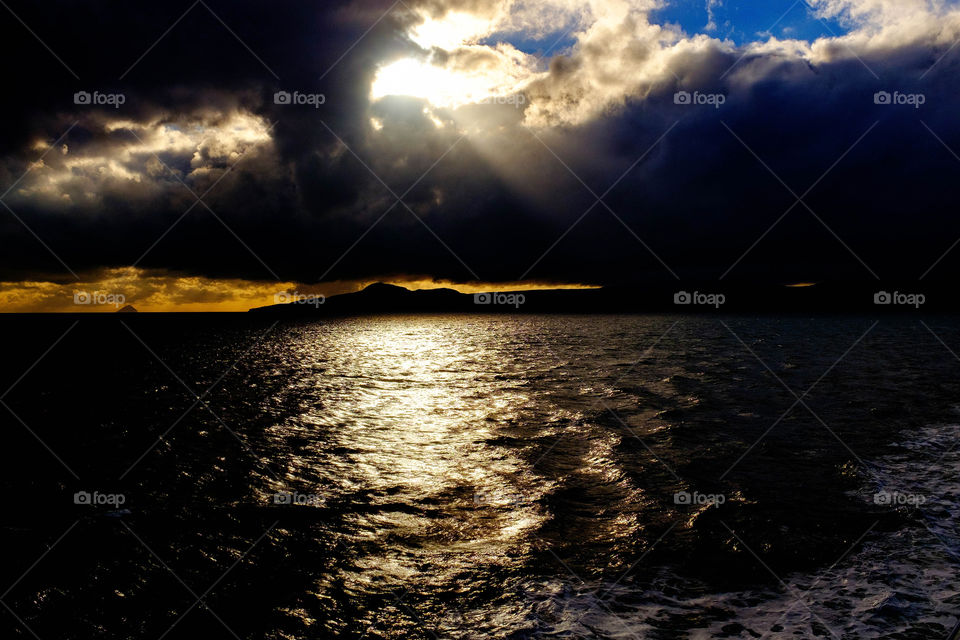 Seascape in a storm with sliver of golden sky