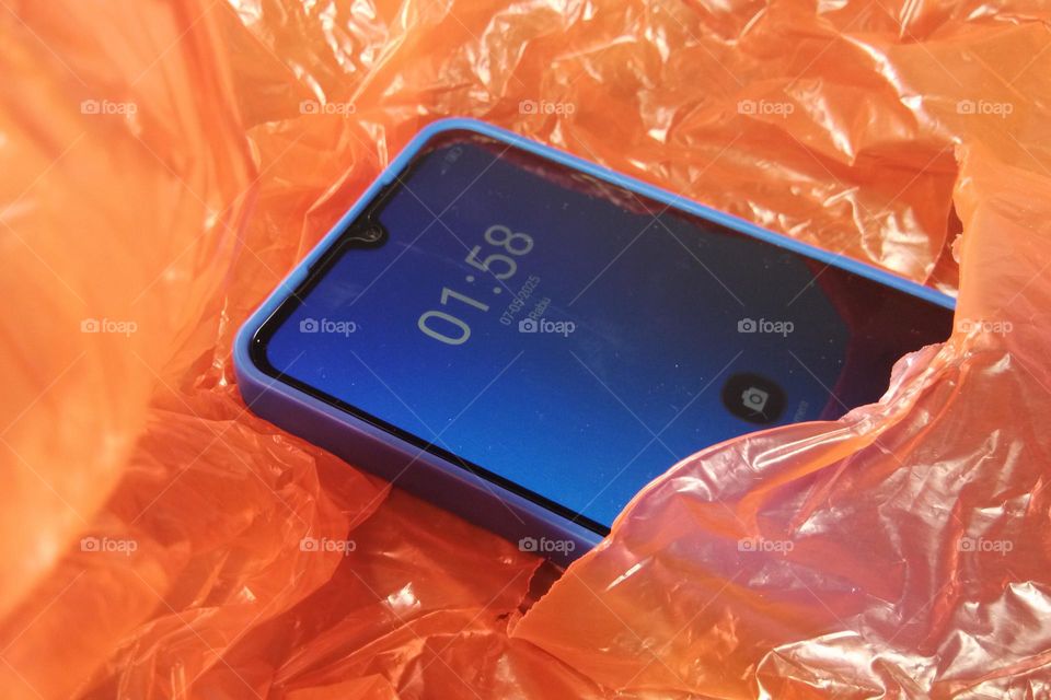 crumpled plastic and smartphone