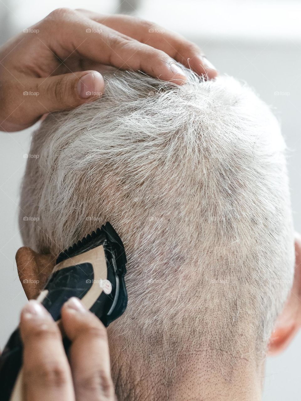 Giving a haircut to grandfather