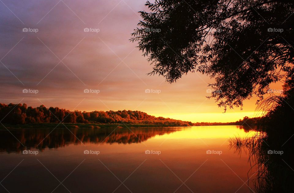 Summer stunning sunset on the river. Soothing landscape