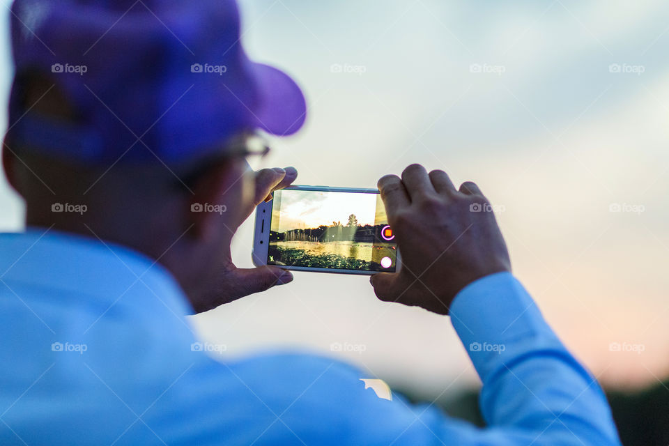 Men taking pictures with mobile phone 