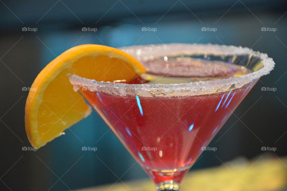 red cocktail with orange wedge and salt