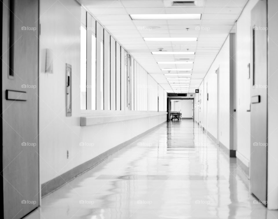 Hospital Hallway in Black and white with a gurney at the end