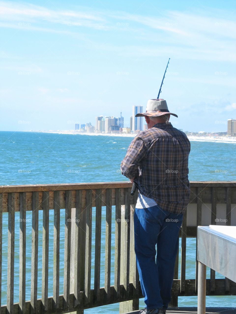 Enjoying Retirement. Loved this older gentleman fishing off the pier