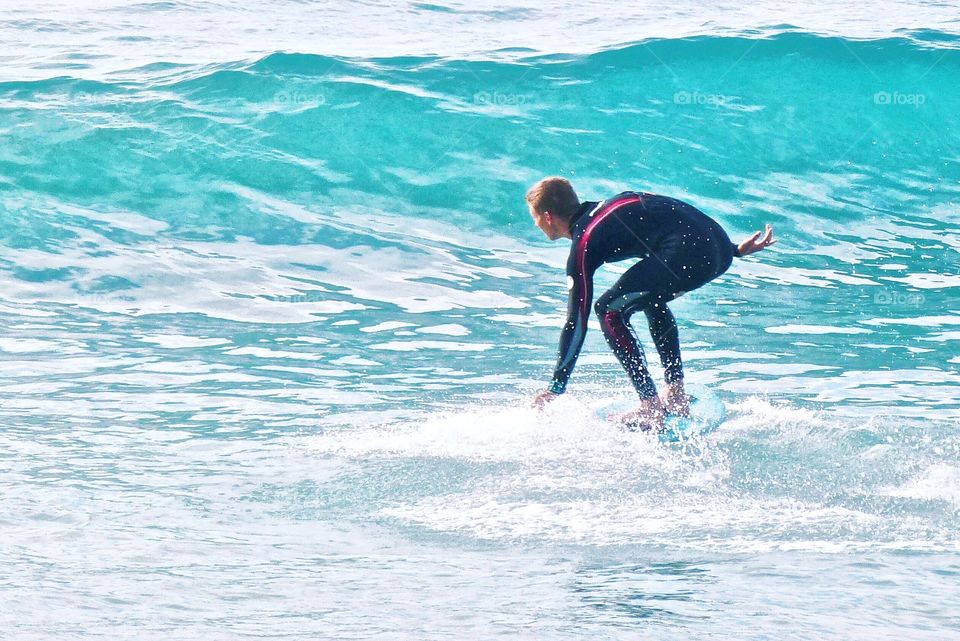 A surfer in Laguna Beach California rides a wave
