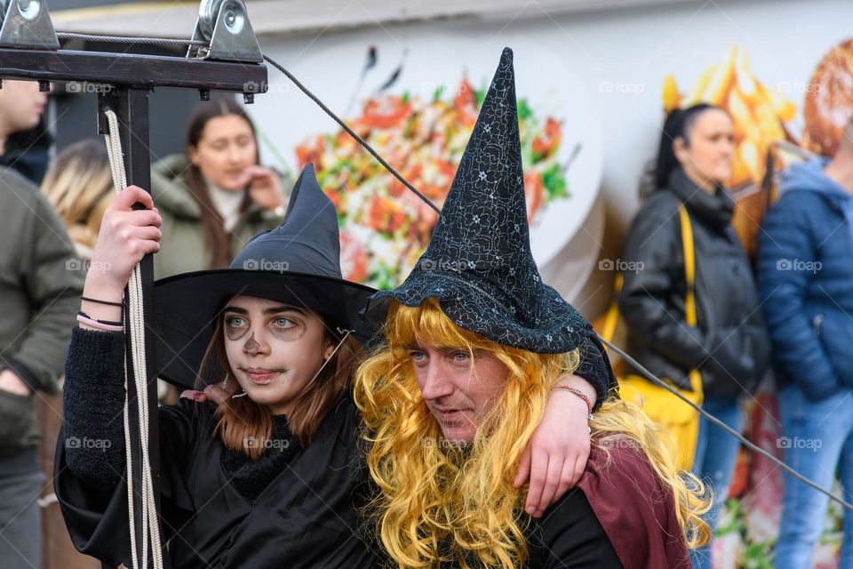 Portrait of girl and man wearing wizard costumes at carnival