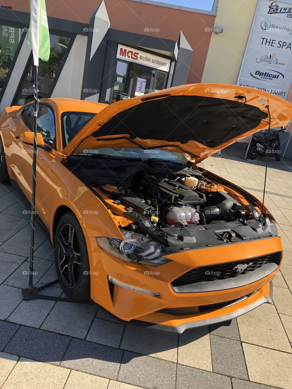 This mustang was outside a shopping mall in America , very beautiful and orange I must say.