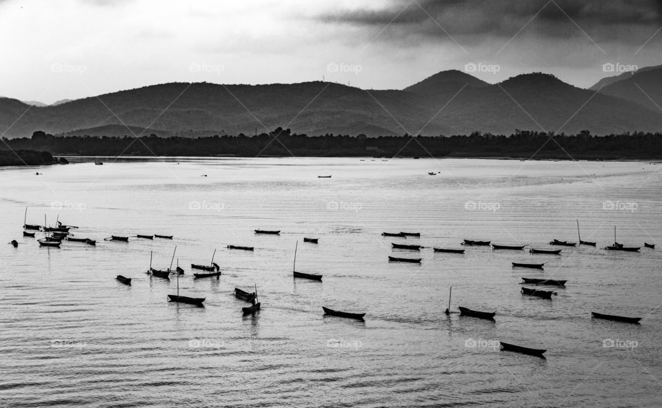 fishermen out on the river in monsoon with their fishing boats