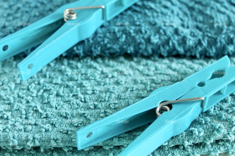 Blue clothespin on blue towels