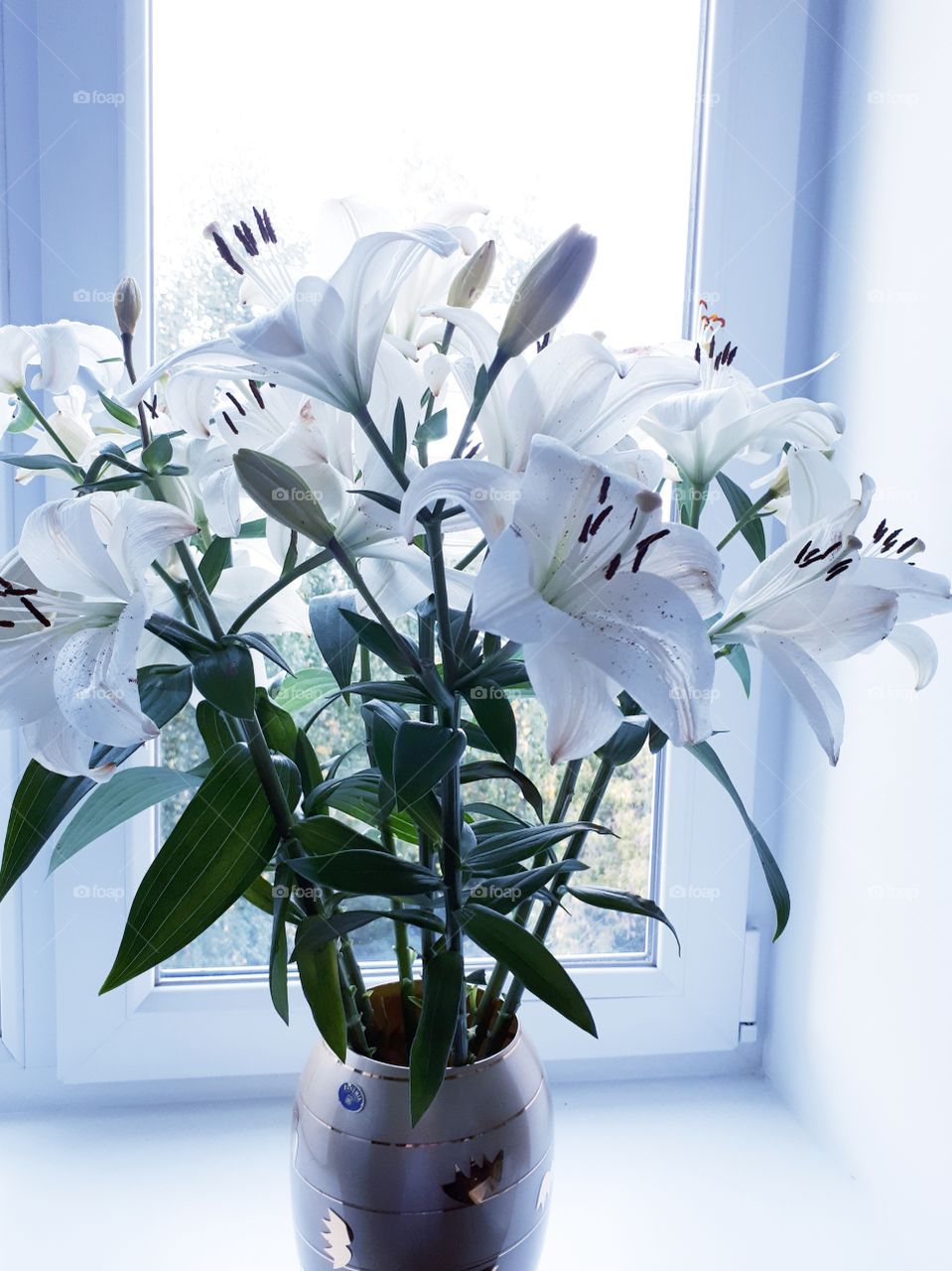 Luxurious bouquet of lilies with a vase