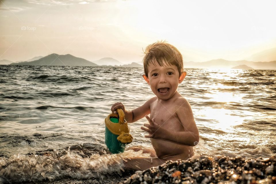 Boy playing with sea water