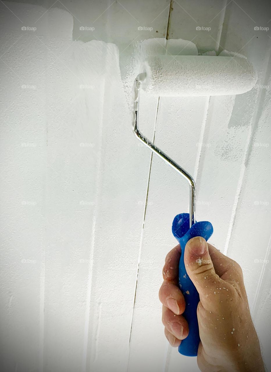 Painter Rolling White Paint On Dirty Look Outdoor Ceiling From Backyard Porch 