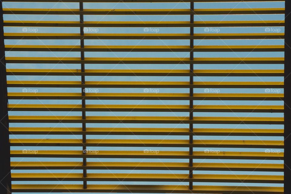 A walkway adjacent to the elevated overhead subway train tracks in the Bronx, New York City.