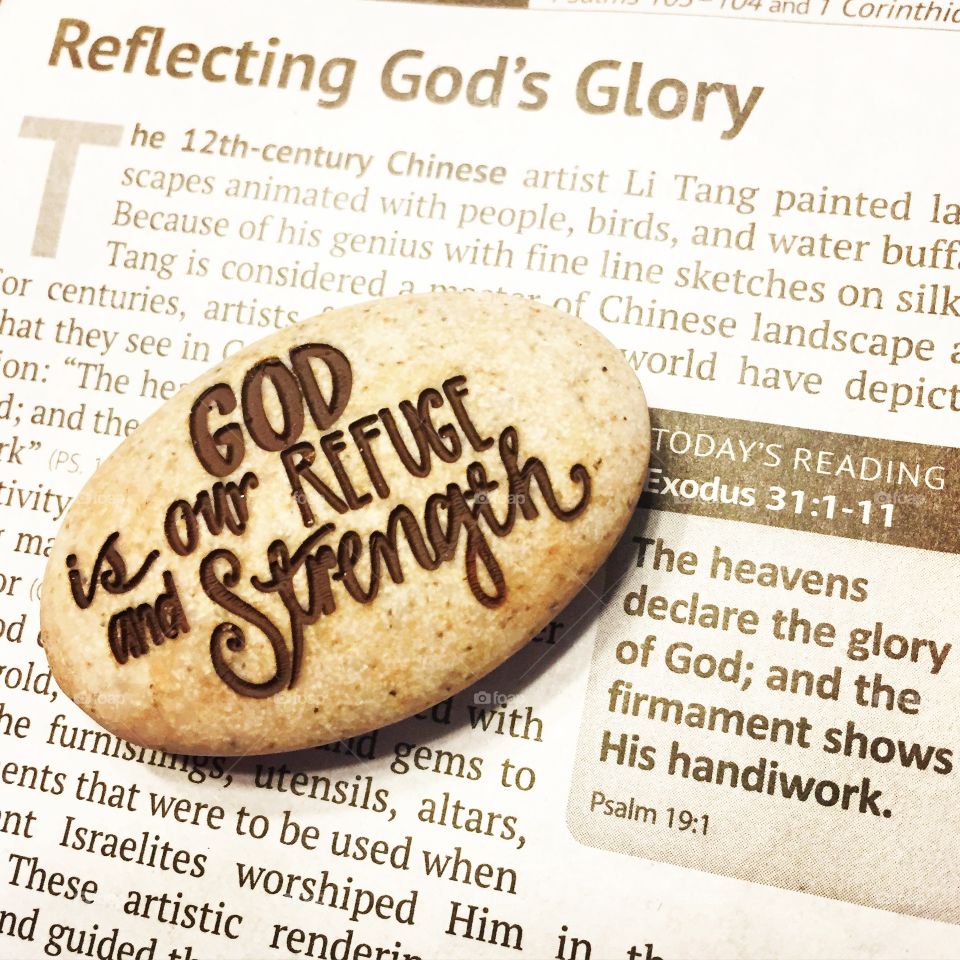 Prayer stone laying on scripture