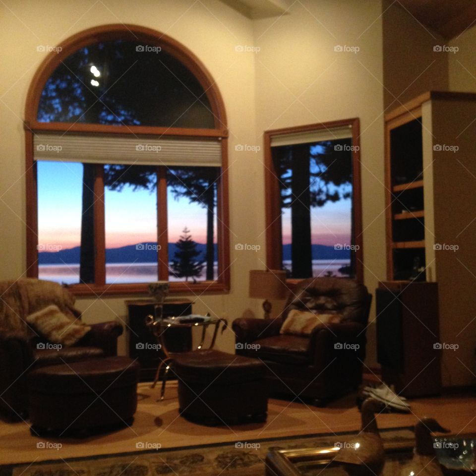 A window Tahoe view . It is an early morning sunrise at Lake Tahoe, California and we get to enjoy it through the window.