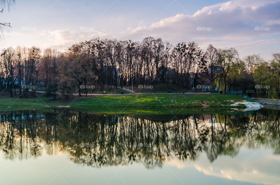 city park with lake in the spring season