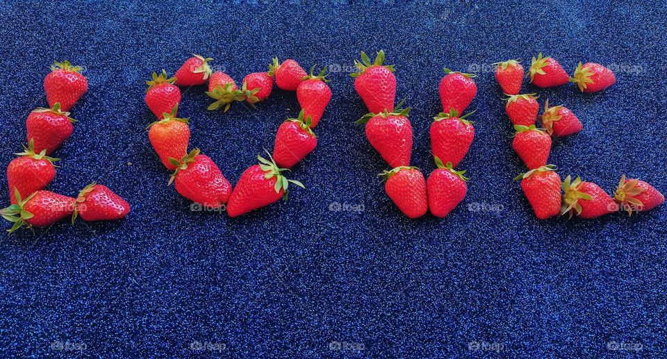 Written "LOVE" with strawberries