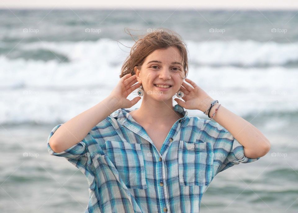 Energetic, Light-Hearted, and Vibrant Portrait of Blonde girl, on sea background