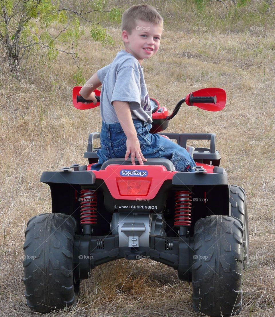 Boy sitting on quad bike