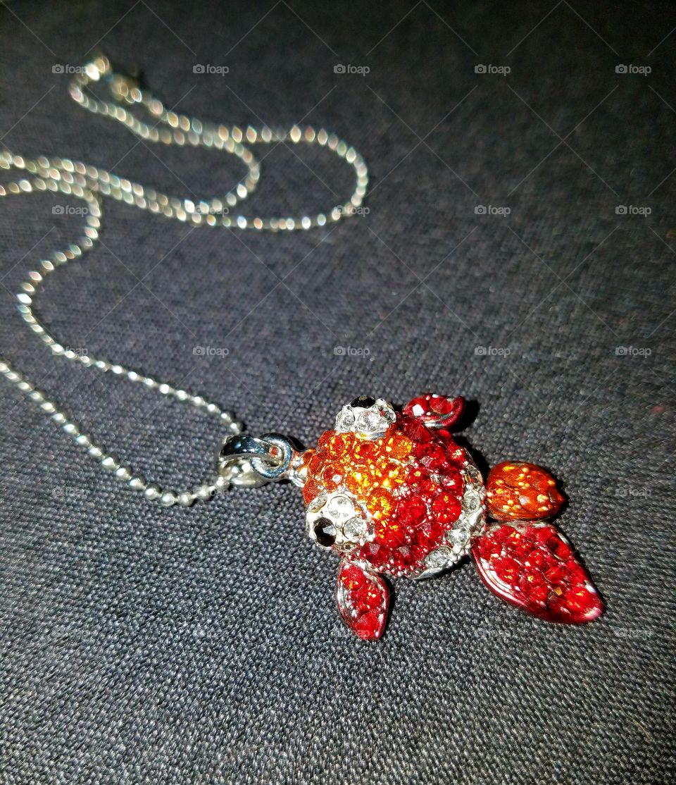 #clash of colour - Goldfish orange necklace with silver on gray background.