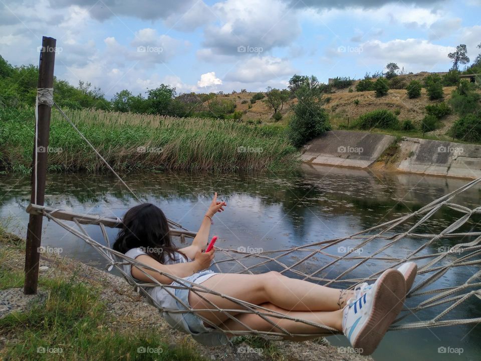 Girl in a hammock on the lake