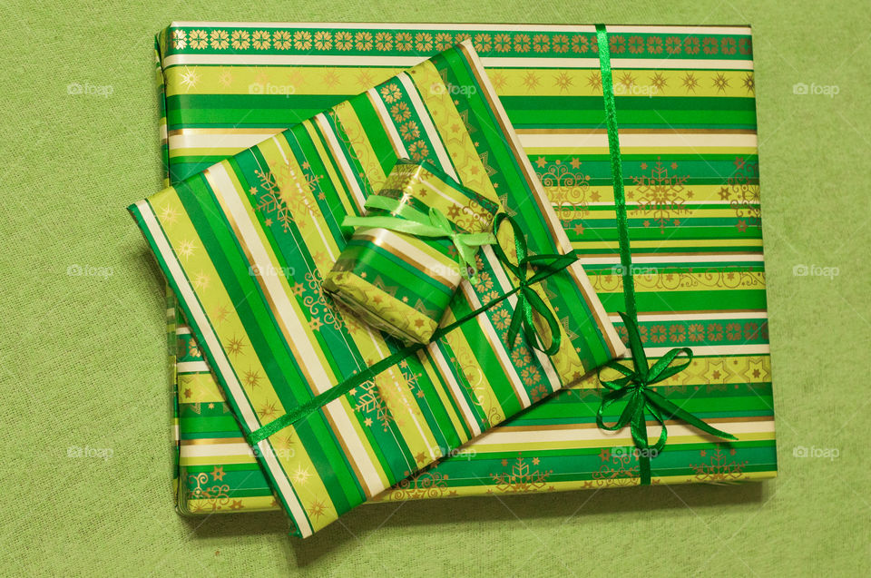 Few Christmas present in green envelopes taken from top