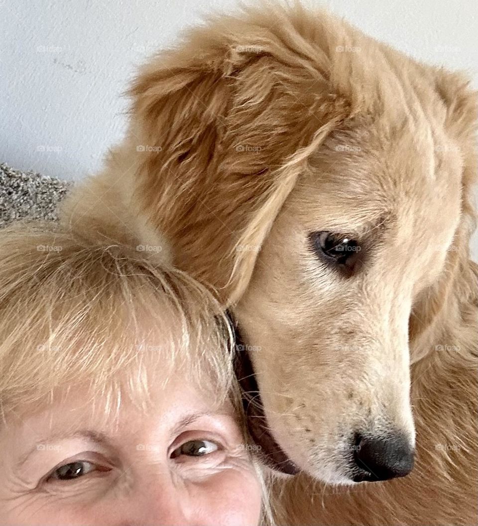 Selfie with a cute young golden retriever 