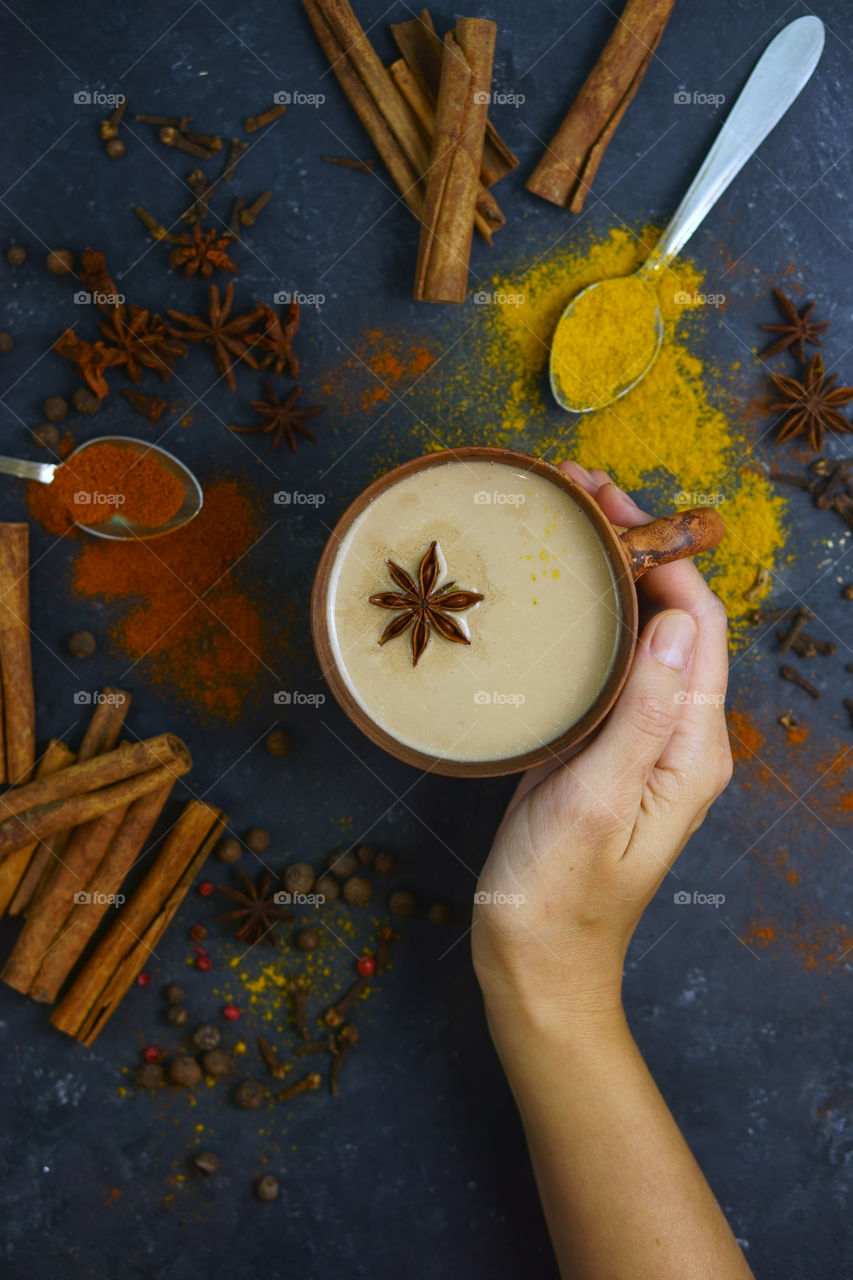 hand holding cup of masala chai