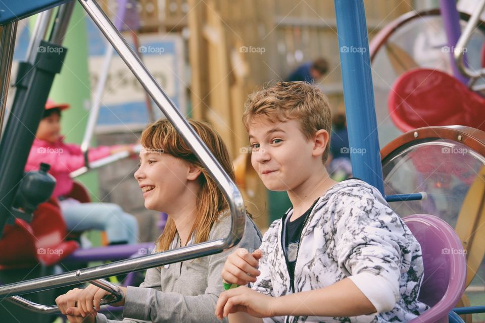 Very happy and excited teens on an amusement ride